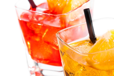 detail of two cocktail with orange slice on top isolated on white backgroundの写真素材