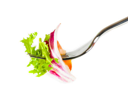 fork with italian fresh salad on top on white background nutrition conceptの写真素材
