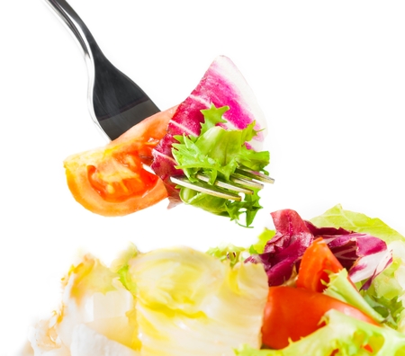 fork on italian fresh salad on white background nutrition conceptの写真素材