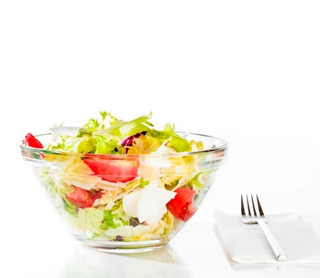 italian fresh salad with fork on white background diet conceptの写真素材