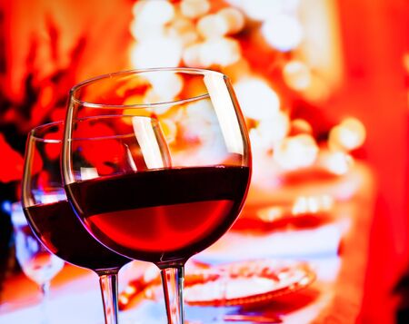 two red wine glasses against restaurant table background, festive and fun conceptの写真素材