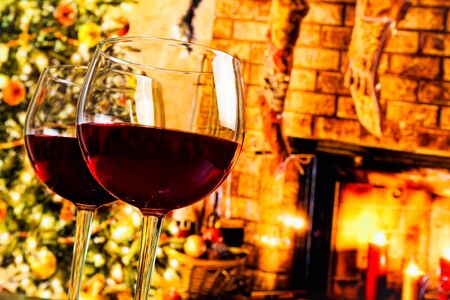 detail of two red wine glasses against christmas tree background, christmas atmosphereの写真素材