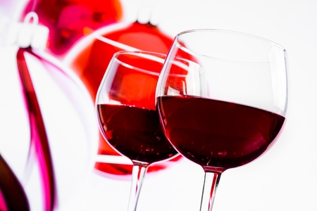 two red wine glasses against christmas decoration background, christmas atmosphereの写真素材