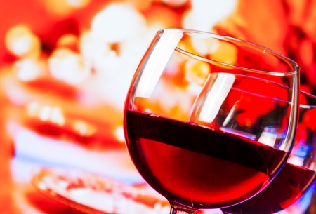 detail of red wine glasses against unfocused restaurant table background, festive and fun conceptの写真素材