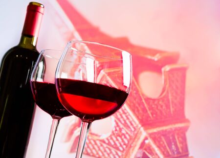 two red wine glasses on blur tower Eiffel background, festive and love conceptの写真素材