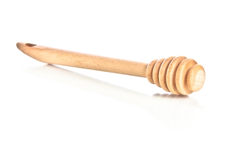 wooden honey dipper isolated on white backgroundの写真素材