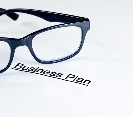 business plan words near glasses on table, business conceptの写真素材