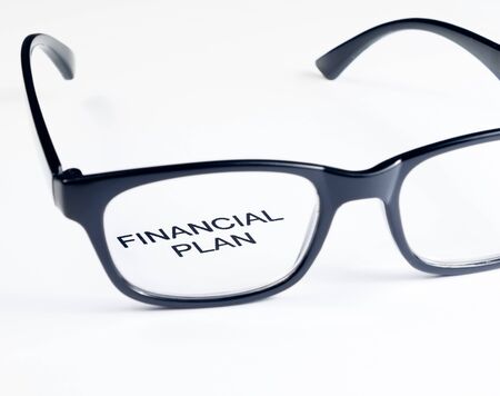 financial plan words see through glasses lens on white background, business conceptの写真素材