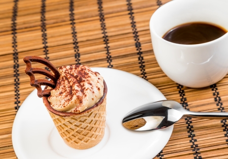 top of view of delicious little coffee cake with chocolate near a cup of coffee on wood backgroundの写真素材