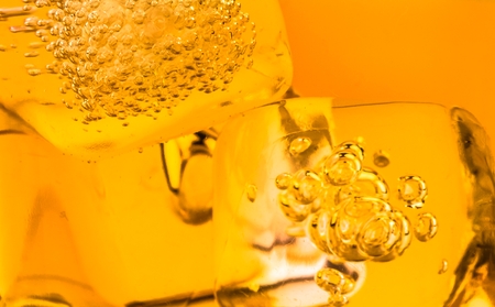 close-up of whiskey in glass with ice used for background, whisy textureの写真素材