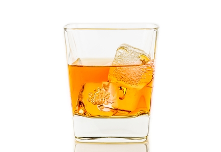 whiskey in glass with ice on white background, whisky relax timeの写真素材