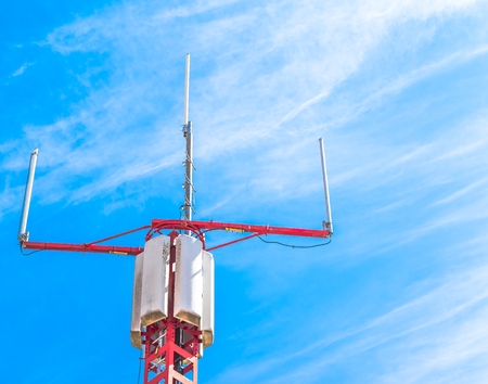 Mobile phone communication repeater antenna under blue skyの写真素材
