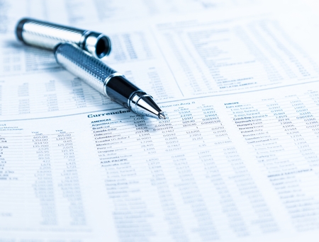 financial business pen on currencies newspaper, business conceptの写真素材