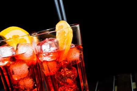 spritz aperitif aperol cocktail with orange slices and ice cubes on black backgroundの写真素材