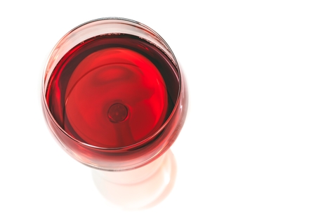 top of view of red wine in the glass isolated on white backgroundの写真素材