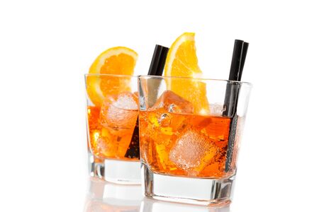 two glasses of spritz aperitif aperol cocktail with orange slices and ice cubes isolated on white backgroundの写真素材