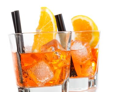 two glasses of spritz aperitif aperol cocktail with orange slices and ice cubes isolated on white backgroundの写真素材
