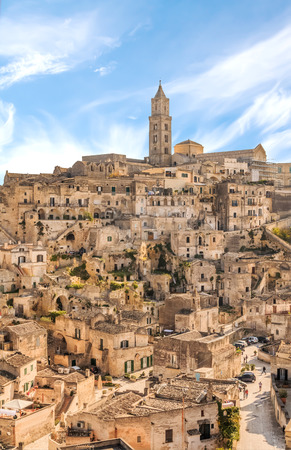 panoramic view of typical stones (Sassi di Matera) and church of Matera UNESCO European Capital of Culture 2019 under blue sky. Basilicata, Italyの写真素材
