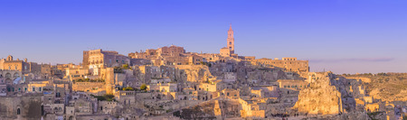 panoramic view of typical stones and church of Matera and the Madonna de Idris under begin sunset sky. Basilicata, Italyの写真素材