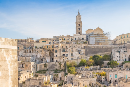 panoramic view of typical stones (Sassi di Matera) and church of Matera UNESCO European Capital of Culture 2019 under blue sky. Basilicata, Italyのeditorial素材
