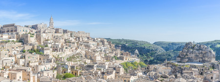 panoramic view of typical stones (Sassi di Matera) and church of Matera UNESCO European Capital of Culture 2019 under blue sky. Basilicata, Italyの写真素材