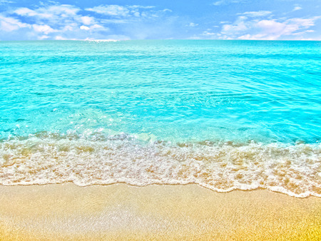 golden sand with beach and tropical sea under blue skyの写真素材