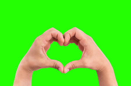 man hands in the form of heart against the chroma key green screen background, hands in shape of love heart valentine day conceptの写真素材