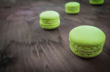 green cake macaron on wood background, maccarone sweet and colorful dessertの写真素材