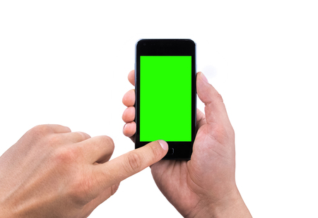 hand  of man use mobile smart phone with chroma key green screen on white background, new technology conceptの写真素材