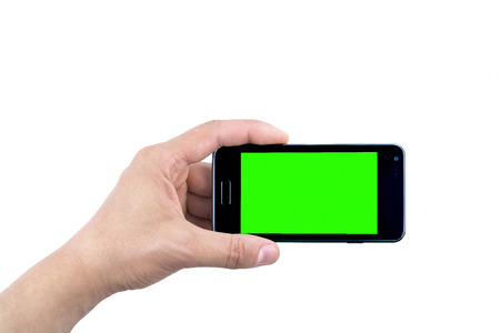 hand of man holding mobile smart phone with chroma key green screen on white background, new technology conceptの写真素材
