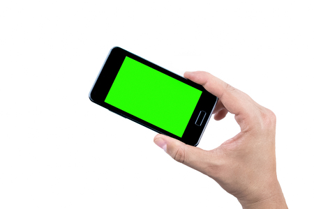 hand of man holding mobile smart phone with chroma key green screen on white background, new technology conceptの写真素材