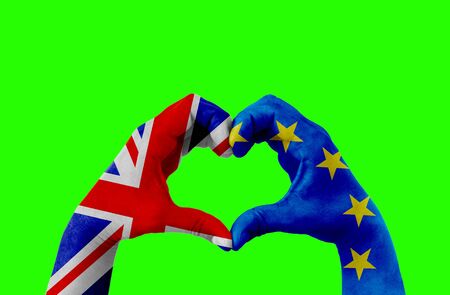brexit, hands of man in heart shape patterned with the flag of blue european union EU and flag of great britain uk on chroma key green screen background, vote referendum for united kingdom exit conceptの写真素材