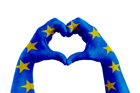 pray for europe, man hands in the form of heart with the flag of europe on the white background, concept for hope and helpful support for the european violence victimsの写真素材