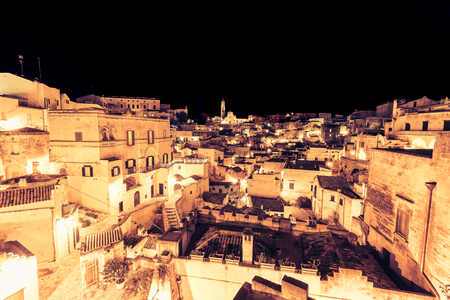 panoramic view of typical stones (Sassi di Matera) and church of Matera UNESCO European Capital of Culture 2019  at nightのeditorial素材