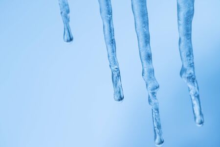 bunch of real icicle in close focus of ice drop, ice stalactites, ice formations in a frozen dayの写真素材