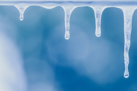 bunch of real icicle in close focus of ice drop, ice stalactites, ice formations in a frozen dayの写真素材