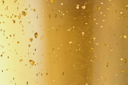 valentine day golden hearts shape rise like frizz champagne bubbles movement on gold background, holiday festive valentine day love conceptの写真素材