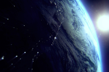 planet earth from the space at night with sun near on black backgroundの写真素材