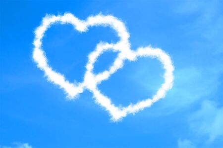 abstract two hearts shape love draw on the blue sky with white clouds background, valentine day holiday event festive symbol signconceptの写真素材