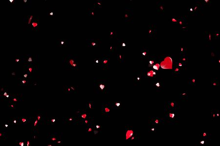 valentine day red hearts shape flowing on black background, holiday festive valentine day love conceptの写真素材