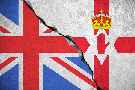 north ireland flag on broken wall and half great britain flag, north ireland vote referendum for exit separate division independence from united kingdom conceptの写真素材