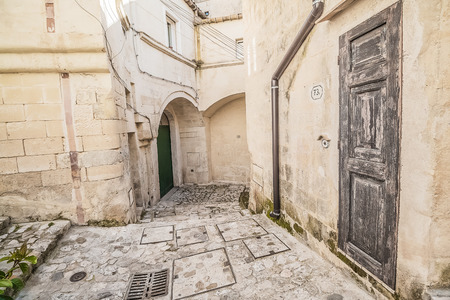 detail view of typical house (Sassi di Matera) and church of Matera under blue skyのeditorial素材