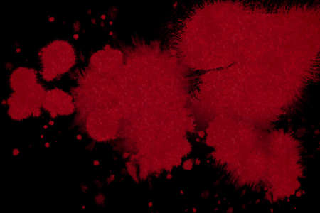 abstract red blood ink splatter on black backgroundの写真素材
