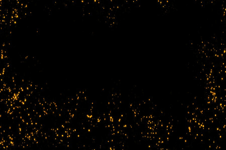 frame of golden glitter sparkle bubbles particles stars on black background, event festive happy new year holiday conceptの写真素材