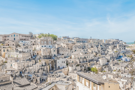 panoramic view of typical stones (Sassi di Matera) near gravina of Matera UNESCO European Capital of Culture 2019 on blue sky. Basilicata, Italyの写真素材