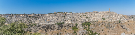 panoramic view of typical stones (Sassi di Matera) and church of Matera UNESCO European Capital of Culture 2019 under blue sky. Basilicata, Italyの写真素材