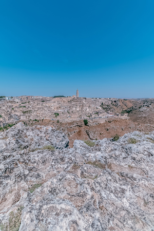 panoramic view of typical stones (Sassi di Matera) and church of Matera UNESCO European Capital of Culture 2019 under blue sky. Basilicata, Italyの写真素材