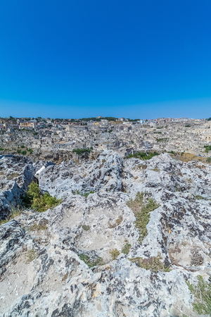 panoramic view of typical stones (Sassi di Matera) and church of Matera UNESCO European Capital of Culture 2019 under blue sky. Basilicata, Italyの写真素材