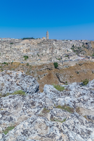 panoramic view of typical stones (Sassi di Matera) and church of Matera UNESCO European Capital of Culture 2019 under blue sky. Basilicata, Italyの写真素材