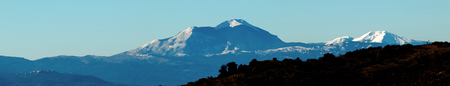 panoramic view of mountain silhouette with snow, natural light tint blue, wild nature conceptの写真素材